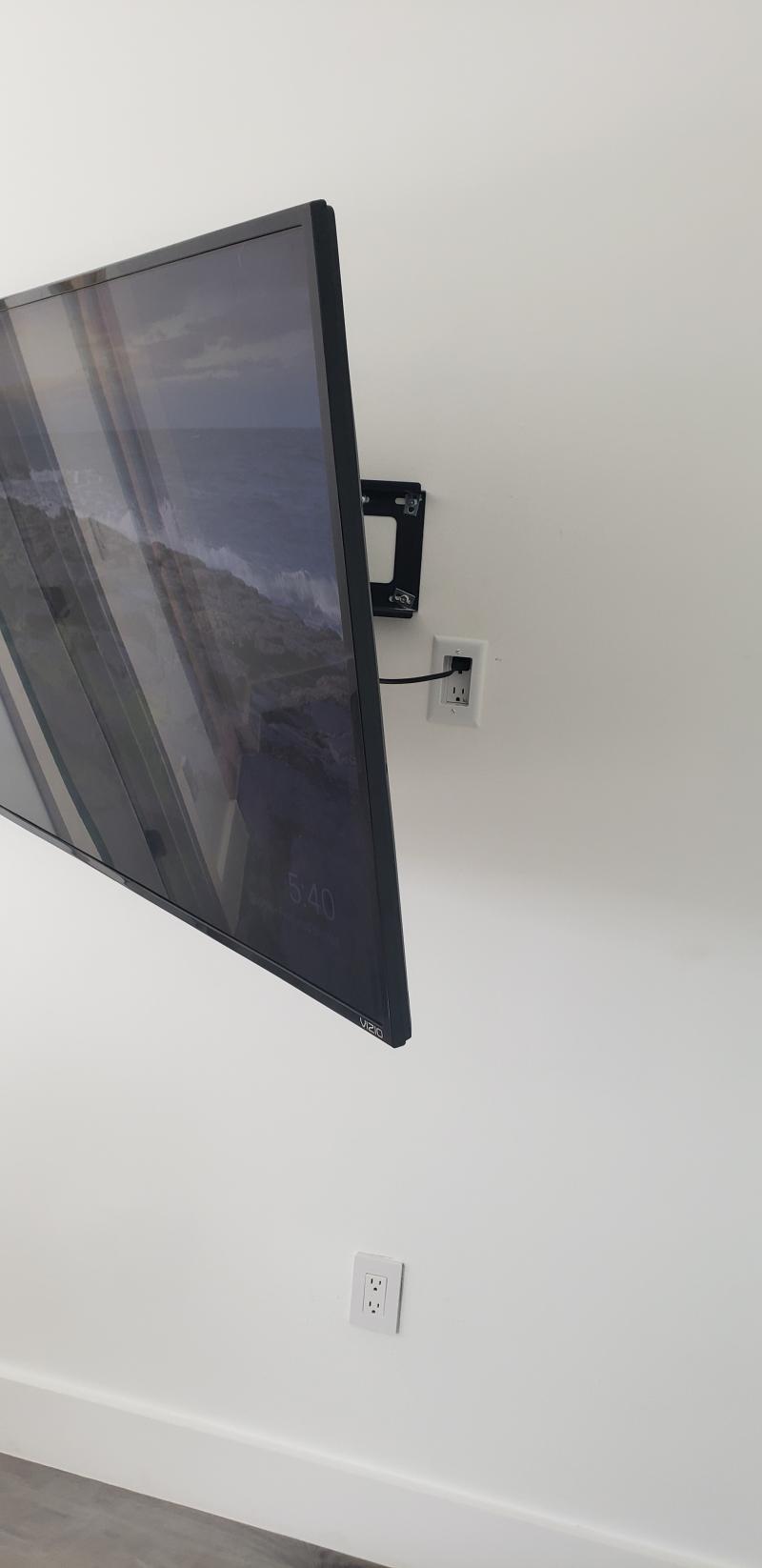 65 inch Full motion TV mount with recessed outlet — living room