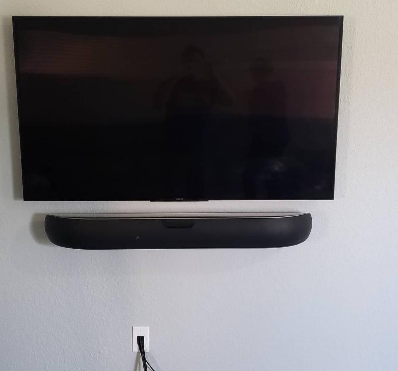 TV mounted above media console with soundbar and concealed cables