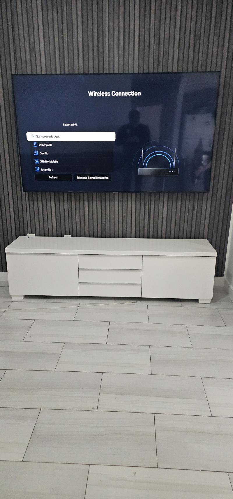 Large flat screen TV mounted on painted accent wall with clean wiring